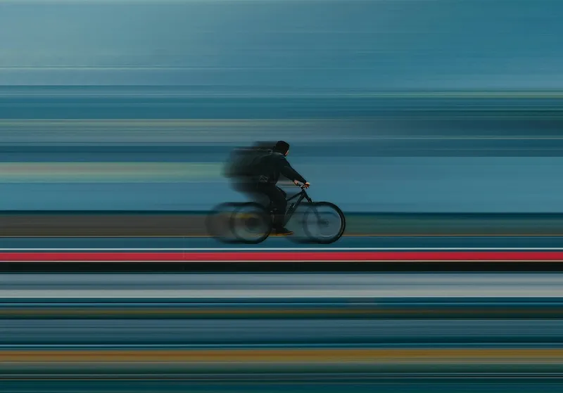 A bicyclist going fast.