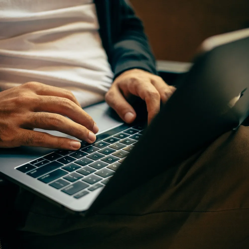 A man working on a laptop.