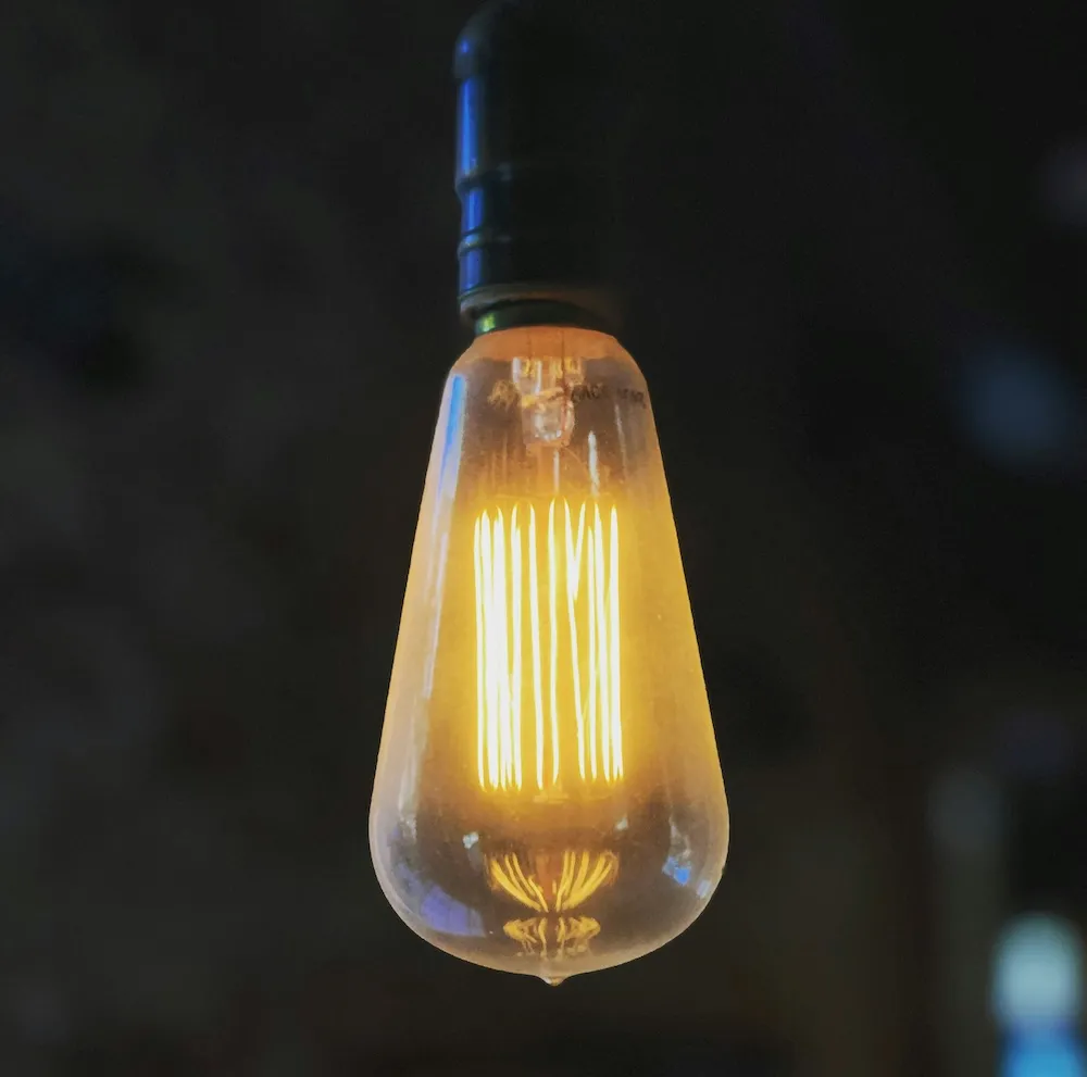 A lightbulb hanging from the ceiling.